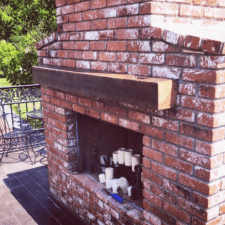 barn beam mantle outdoor fireplace